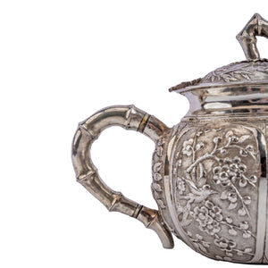 Antique Chinese Silver Teapot with decorative repousse panels and bamboo elements c.1890
