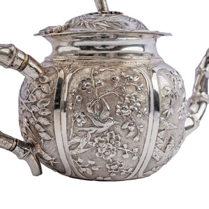Antique Chinese Silver Teapot with decorative repousse panels and bamboo elements c.1890